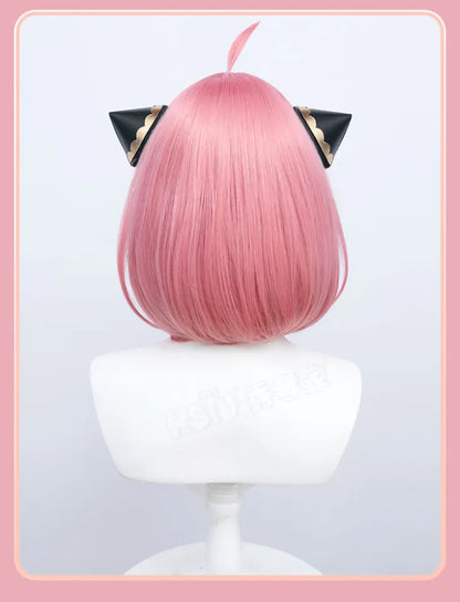 Back view of pink Anya Forger inspired cosplay wig with black and gold hair accessories