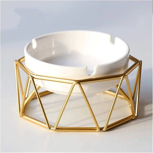 White ceramic ashtray in geometric golden metal wire holder